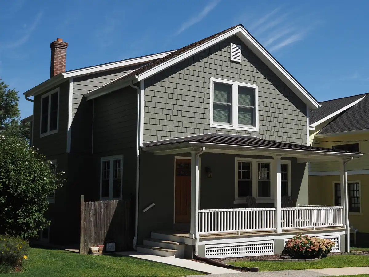Two-story frame house with a front porch and green lawn