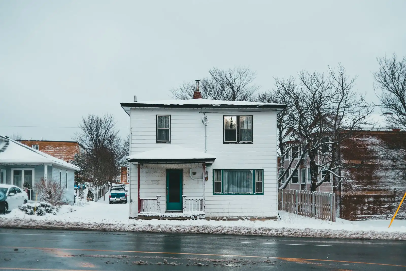 Row of older two-story homes on a residential street in a Midwest city