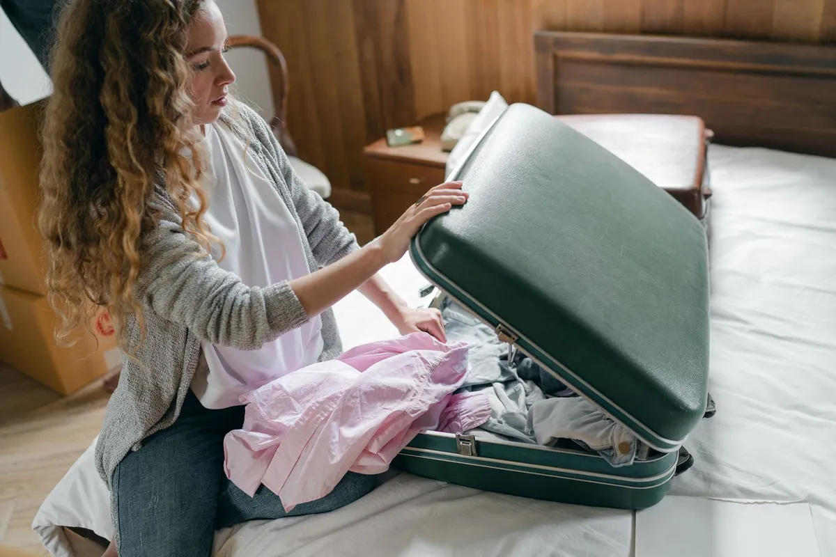 Bedding and clothes packed in clear sealed plastic bags in an apartment bedroom