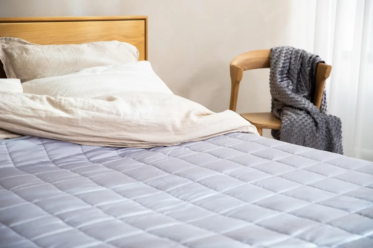 Mattress with a zippered protective encasement on a bed frame