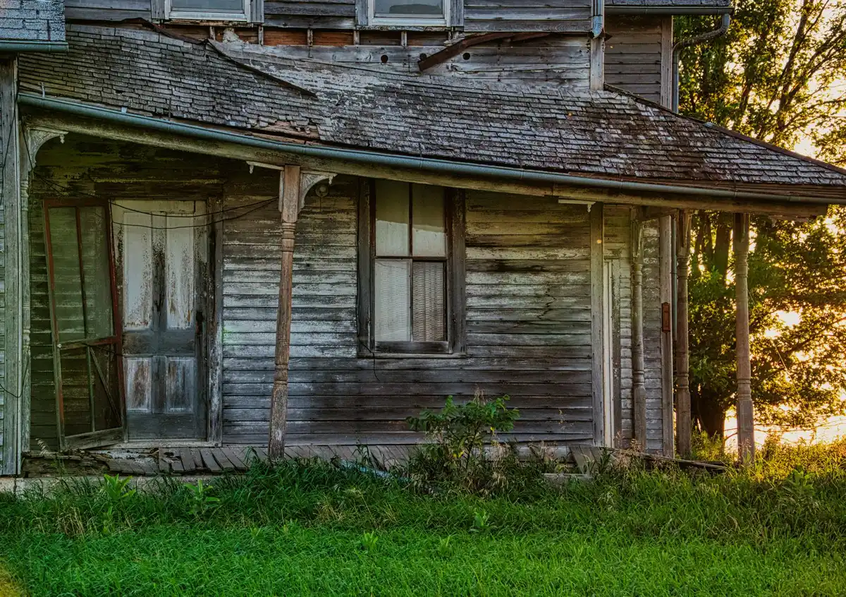 Older two-story frame house with a front porch on a city street