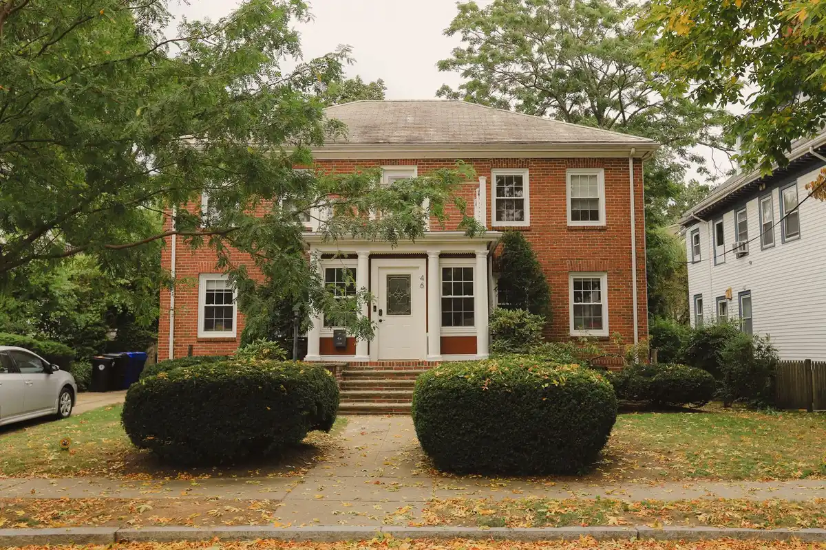 Older two-story house on a tree-lined street in an Ohio neighborhood in autumn
