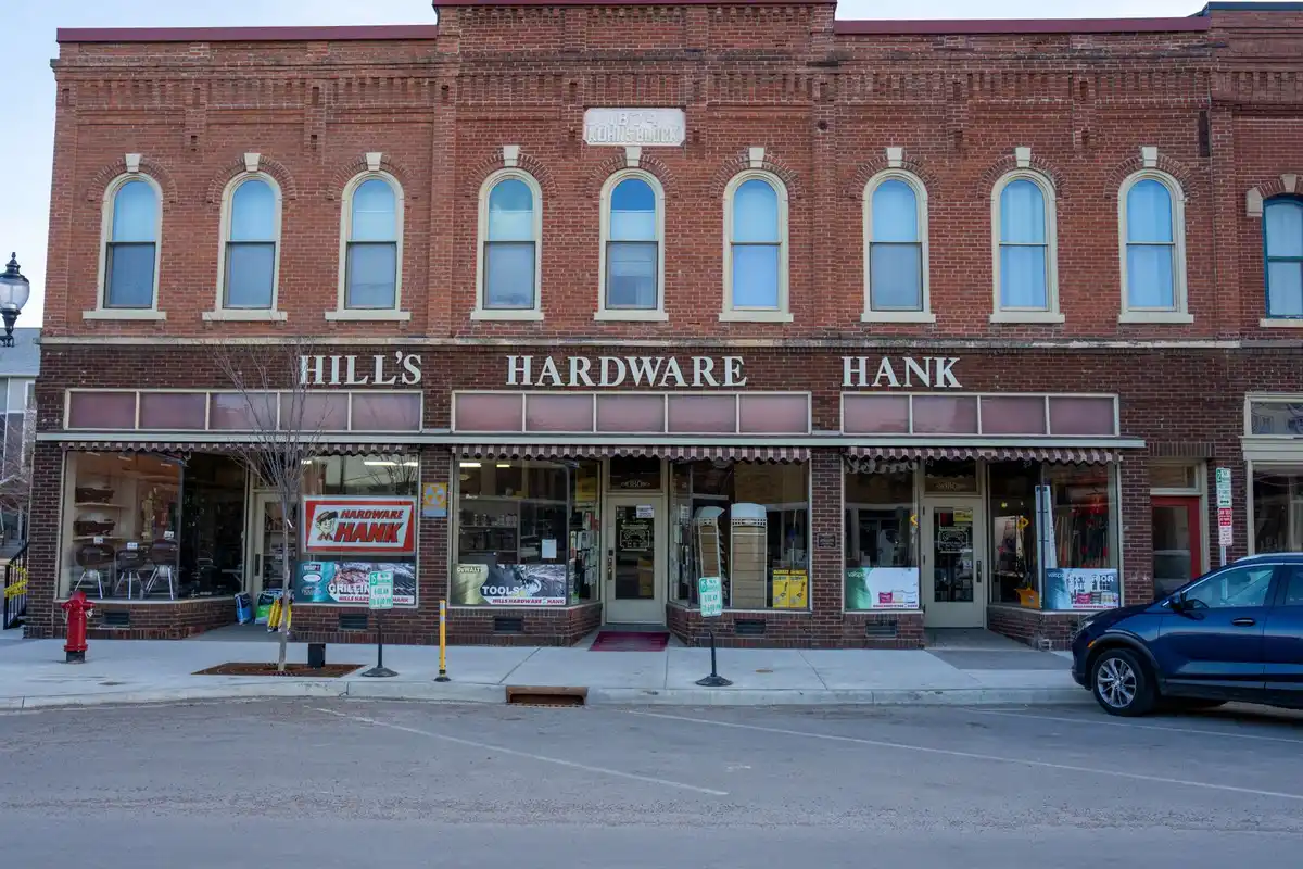 Row of older brick commercial buildings with storefronts on a downtown street