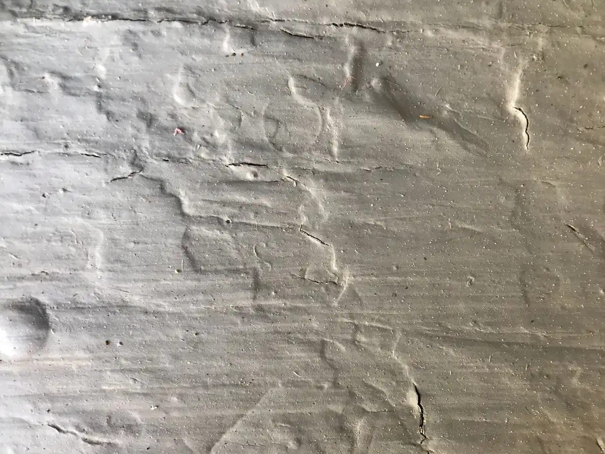 Gap around a pipe entering an old basement wall