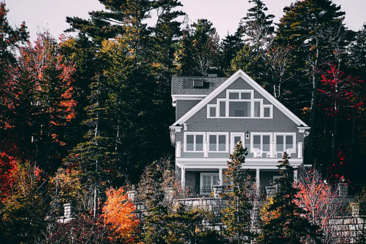 Sunny vinyl siding and window trim on a two story house in autumn