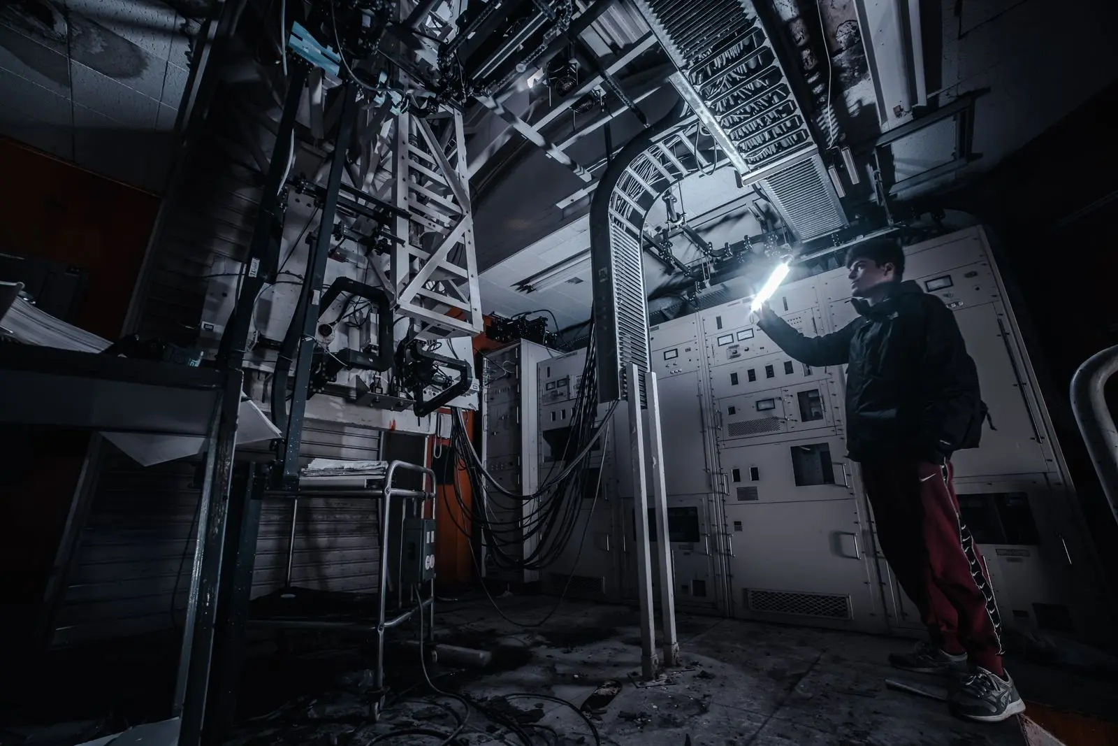Pest control technician checking a basement wall with a flashlight
