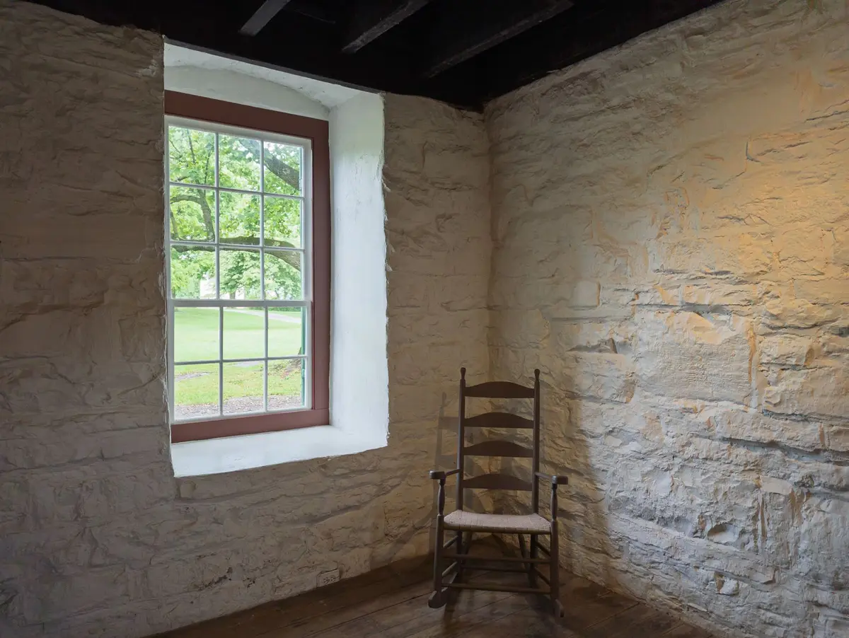 Basement with a stone foundation wall and a small window