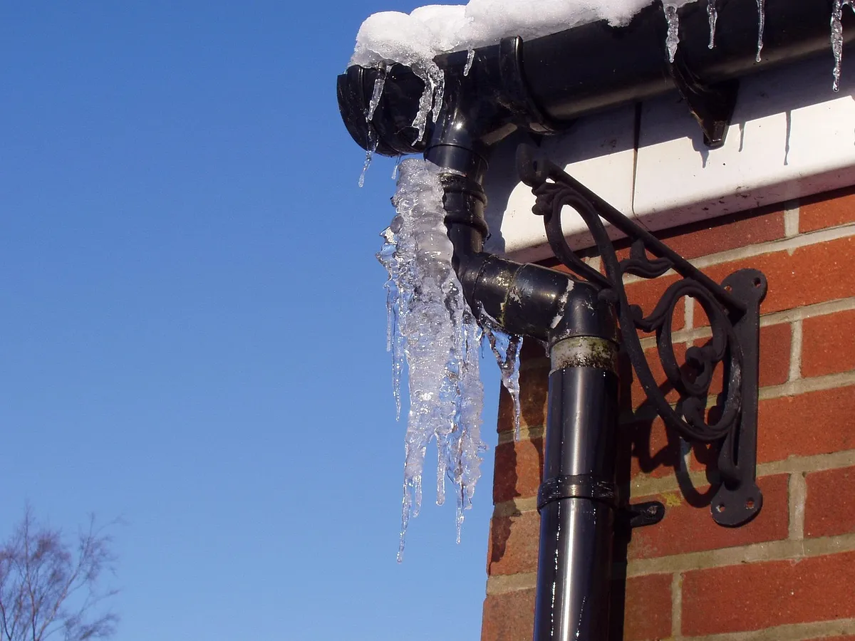 Downspout directing rainwater away from a house foundation
